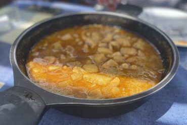 Sartén de hierro fundido con sepia con patatas